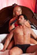 weapon, gun, Sexy sensual heterosexual couple, man, young caucasian woman in love on bed kissing, hugging. Beautiful passionate couple is having sex in a bedroom. Portrait of passion, pleasure, sex, relationship. Copulating