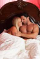 Sexy sensual heterosexual couple, man, young caucasian woman in love on bed kissing, hugging. Beautiful passionate couple is having sex in a bedroom. Portrait of passion, pleasure, sex, relationship. Copulating