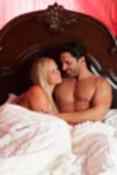 Sexy sensual heterosexual couple, man, young caucasian woman in love on bed kissing, hugging. Beautiful passionate couple is having sex in a bedroom. Portrait of passion, pleasure, sex, relationship. Copulating