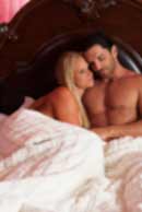 Sexy sensual heterosexual couple, man, young caucasian woman in love on bed kissing, hugging. Beautiful passionate couple is having sex in a bedroom. Portrait of passion, pleasure, sex, relationship. Copulating