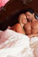 Sexy sensual heterosexual couple, man, young caucasian woman in love on bed kissing, hugging. Beautiful passionate couple is having sex in a bedroom. Portrait of passion, pleasure, sex, relationship. Copulating