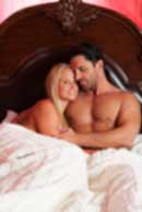 Sexy sensual heterosexual couple, man, young caucasian woman in love on bed kissing, hugging. Beautiful passionate couple is having sex in a bedroom. Portrait of passion, pleasure, sex, relationship. Copulating