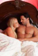 Sexy sensual heterosexual couple, man, young caucasian woman in love on bed kissing, hugging. Beautiful passionate couple is having sex in a bedroom. Portrait of passion, pleasure, sex, relationship. Copulating