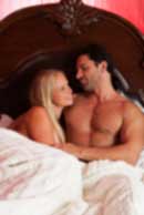 Sexy sensual heterosexual couple, man, young caucasian woman in love on bed kissing, hugging. Beautiful passionate couple is having sex in a bedroom. Portrait of passion, pleasure, sex, relationship. Copulating