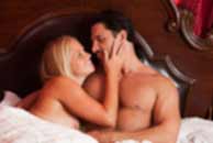 Sexy sensual heterosexual couple, man, young caucasian woman in love on bed kissing, hugging. Beautiful passionate couple is having sex in a bedroom. Portrait of passion, pleasure, sex, relationship. Copulating