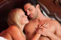 Sexy sensual heterosexual couple, man, young caucasian woman in love on bed kissing, hugging. Beautiful passionate couple is having sex in a bedroom. Portrait of passion, pleasure, sex, relationship. Copulating