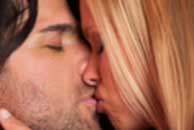 kissing Sexy sensual heterosexual couple, man, young caucasian woman in love on bed kissing, hugging. Beautiful passionate couple is having sex in a bedroom. Portrait of passion, pleasure, sex, relationship. Copulating