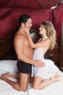 Sexy sensual heterosexual couple, man, young caucasian woman in love on bed kissing, hugging. Beautiful passionate couple is having sex in a bedroom. Portrait of passion, pleasure, sex, relationship. Copulating