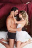 Sexy sensual heterosexual couple, man, young caucasian woman in love on bed kissing, hugging. Beautiful passionate couple is having sex in a bedroom. Portrait of passion, pleasure, sex, relationship. Copulating