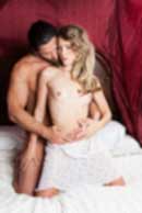 Sexy sensual heterosexual couple, man, young caucasian woman in love on bed kissing, hugging. Beautiful passionate couple is having sex in a bedroom. Portrait of passion, pleasure, sex, relationship. Copulating