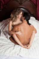 Sexy sensual heterosexual couple, man, young caucasian woman in love on bed kissing, hugging. Beautiful passionate couple is having sex in a bedroom. Portrait of passion, pleasure, sex, relationship. Copulating