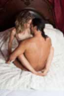 Sexy sensual heterosexual couple, man, young caucasian woman in love on bed kissing, hugging. Beautiful passionate couple is having sex in a bedroom. Portrait of passion, pleasure, sex, relationship. Copulating