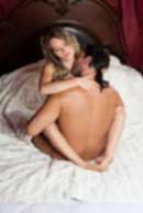 Sexy sensual heterosexual couple, man, young caucasian woman in love on bed kissing, hugging. Beautiful passionate couple is having sex in a bedroom. Portrait of passion, pleasure, sex, relationship. Copulating