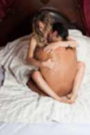 Sexy sensual heterosexual couple, man, young caucasian woman in love on bed kissing, hugging. Beautiful passionate couple is having sex in a bedroom. Portrait of passion, pleasure, sex, relationship. Copulating