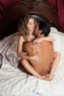 Sexy sensual heterosexual couple, man, young caucasian woman in love on bed kissing, hugging. Beautiful passionate couple is having sex in a bedroom. Portrait of passion, pleasure, sex, relationship. Copulating