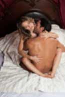 Sexy sensual heterosexual couple, man, young caucasian woman in love on bed kissing, hugging. Beautiful passionate couple is having sex in a bedroom. Portrait of passion, pleasure, sex, relationship. Copulating