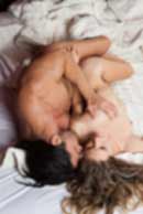 Sexy sensual heterosexual couple, man, young caucasian woman in love on bed kissing, hugging. Beautiful passionate couple is having sex in a bedroom. Portrait of passion, pleasure, sex, relationship. Copulating