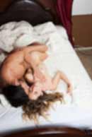 Sexy sensual heterosexual couple, man, young caucasian woman in love on bed kissing, hugging. Beautiful passionate couple is having sex in a bedroom. Portrait of passion, pleasure, sex, relationship. Copulating