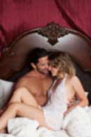 Sexy sensual heterosexual couple, man, young caucasian woman in love on bed kissing, hugging. Beautiful passionate couple is having sex in a bedroom. Portrait of passion, pleasure, sex, relationship. Copulating