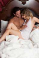 Sexy sensual heterosexual couple, man, young caucasian woman in love on bed kissing, hugging. Beautiful passionate couple is having sex in a bedroom. Portrait of passion, pleasure, sex, relationship. Copulating