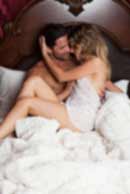 Sexy sensual heterosexual couple, man, young caucasian woman in love on bed kissing, hugging. Beautiful passionate couple is having sex in a bedroom. Portrait of passion, pleasure, sex, relationship. Copulating