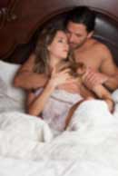 Sexy sensual heterosexual couple, man, young caucasian woman in love on bed kissing, hugging. Beautiful passionate couple is having sex in a bedroom. Portrait of passion, pleasure, sex, relationship. Copulating