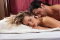 Sexy sensual heterosexual couple, man, young caucasian woman in love on bed kissing, hugging. Beautiful passionate couple is having sex in a bedroom. Portrait of passion, pleasure, sex, relationship. Copulating