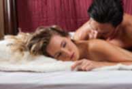 Sexy sensual heterosexual couple, man, young caucasian woman in love on bed kissing, hugging. Beautiful passionate couple is having sex in a bedroom. Portrait of passion, pleasure, sex, relationship. Copulating