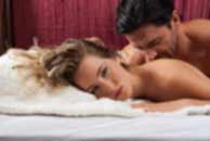 Sexy sensual heterosexual couple, man, young caucasian woman in love on bed kissing, hugging. Beautiful passionate couple is having sex in a bedroom. Portrait of passion, pleasure, sex, relationship. Copulating