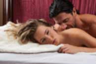 Sexy sensual heterosexual couple, man, young caucasian woman in love on bed kissing, hugging. Beautiful passionate couple is having sex in a bedroom. Portrait of passion, pleasure, sex, relationship. Copulating
