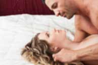 Sexy sensual heterosexual couple, man, young caucasian woman in love on bed kissing, hugging. Beautiful passionate couple is having sex in a bedroom. Portrait of passion, pleasure, sex, relationship. Copulating